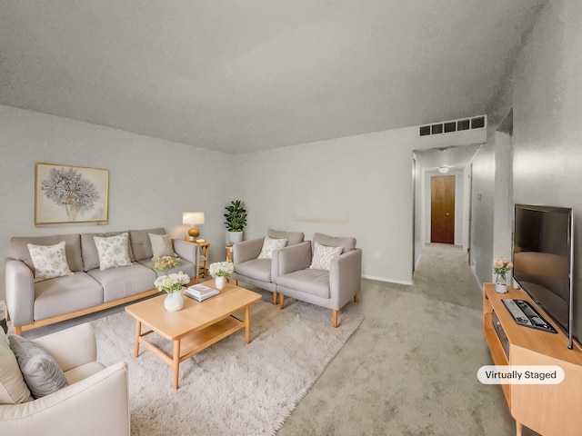 carpeted living room featuring visible vents and baseboards