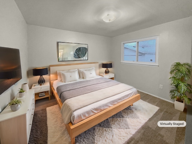 carpeted bedroom featuring baseboards