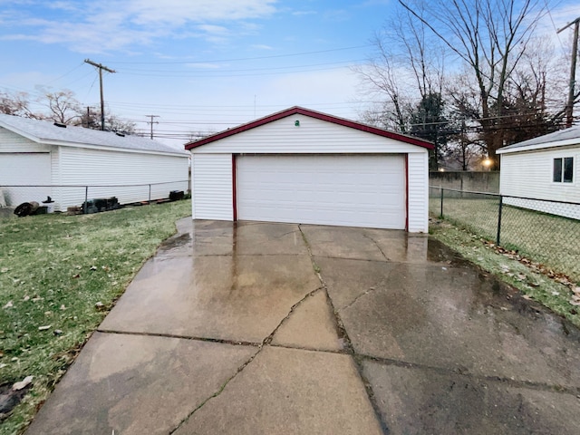 detached garage featuring fence