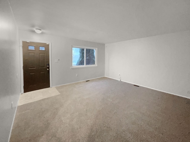 carpeted entryway featuring visible vents