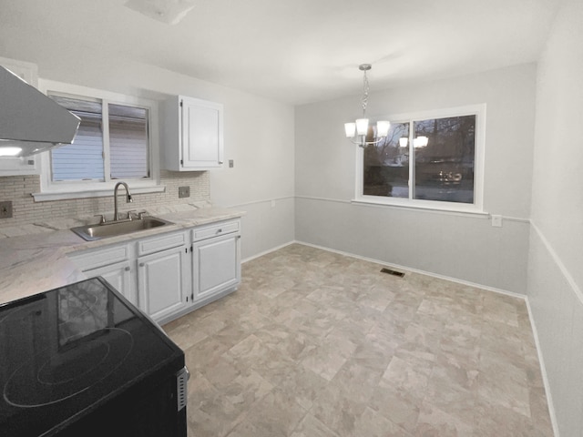 kitchen featuring a sink, visible vents, white cabinets, decorative backsplash, and black electric range oven
