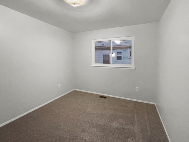 carpeted spare room with baseboards and visible vents