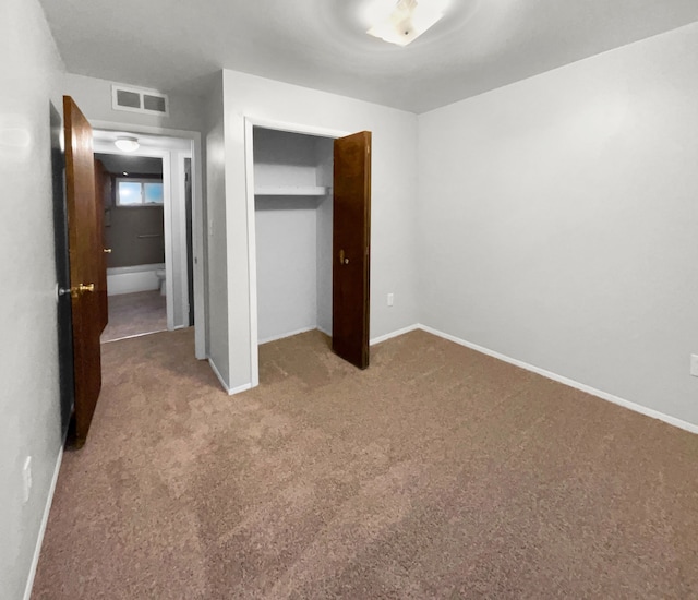 unfurnished bedroom with carpet floors, a closet, visible vents, and baseboards