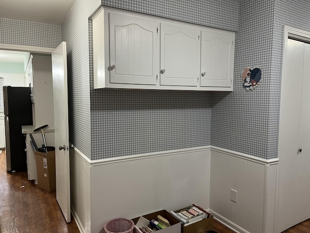 washroom with wallpapered walls, dark wood-style floors, and wainscoting