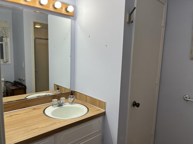 full bathroom featuring a stall shower and vanity