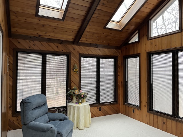 sunroom / solarium featuring wooden ceiling and lofted ceiling with skylight