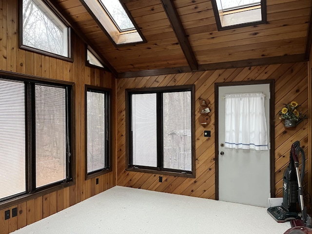 sunroom / solarium with lofted ceiling with skylight and wooden ceiling