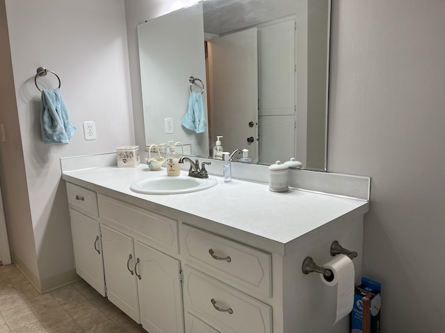 bathroom with baseboards and vanity