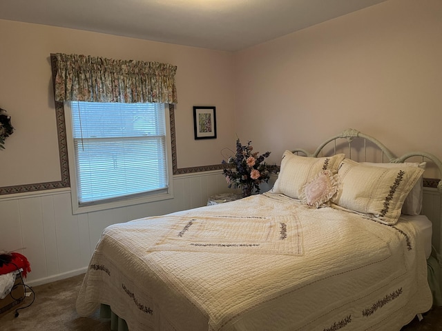 carpeted bedroom with wainscoting