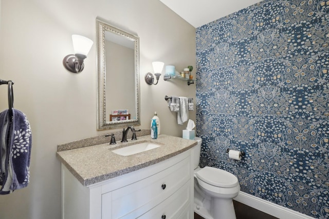 bathroom featuring toilet and vanity