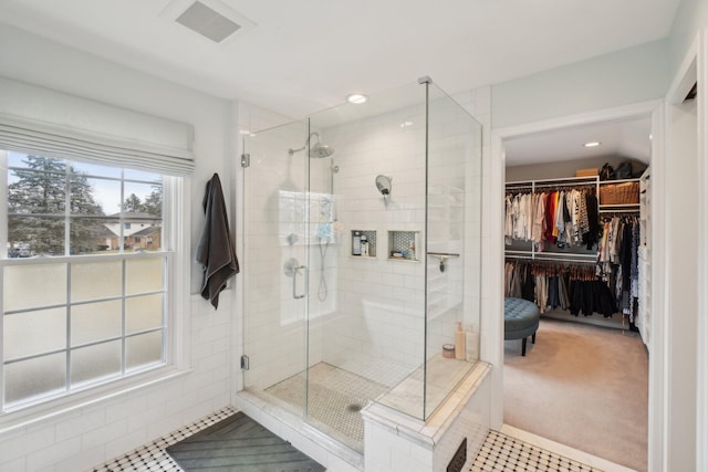 full bath with a spacious closet, a stall shower, visible vents, and recessed lighting