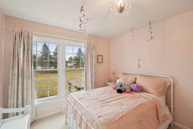 bedroom featuring light colored carpet and baseboards