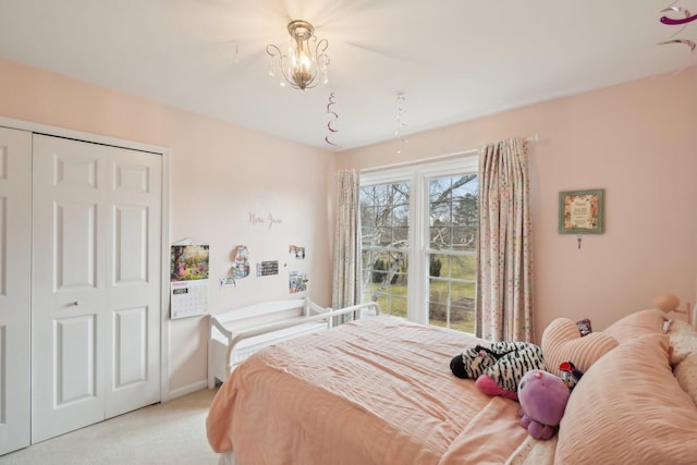 bedroom featuring light carpet and a closet