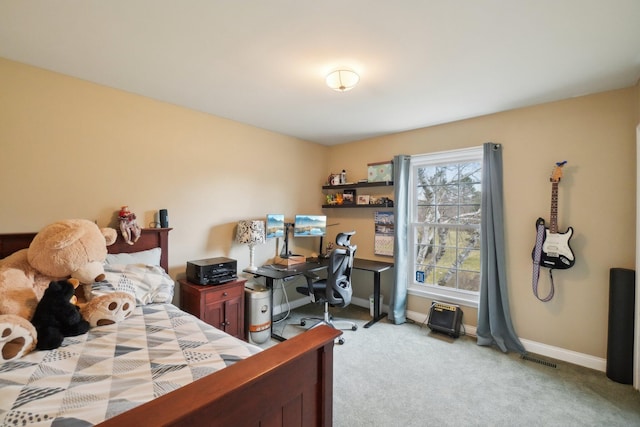 bedroom with baseboards and light colored carpet