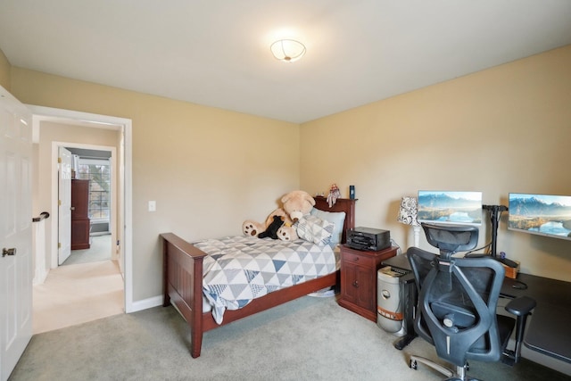 bedroom with baseboards and light colored carpet