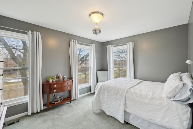 bedroom featuring light colored carpet, visible vents, and baseboards