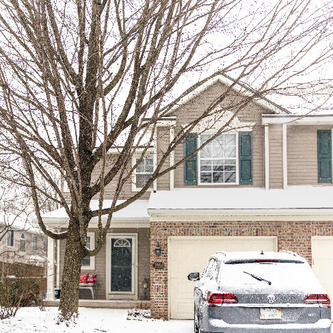 view of front facade featuring an attached garage and brick siding