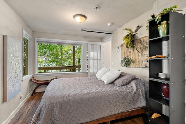 bedroom featuring baseboards and wood finished floors