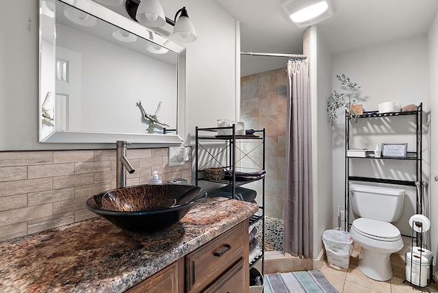 bathroom featuring decorative backsplash, toilet, tile patterned flooring, vanity, and a shower stall