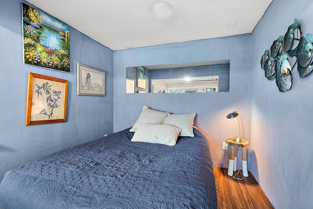 bedroom featuring wood finished floors