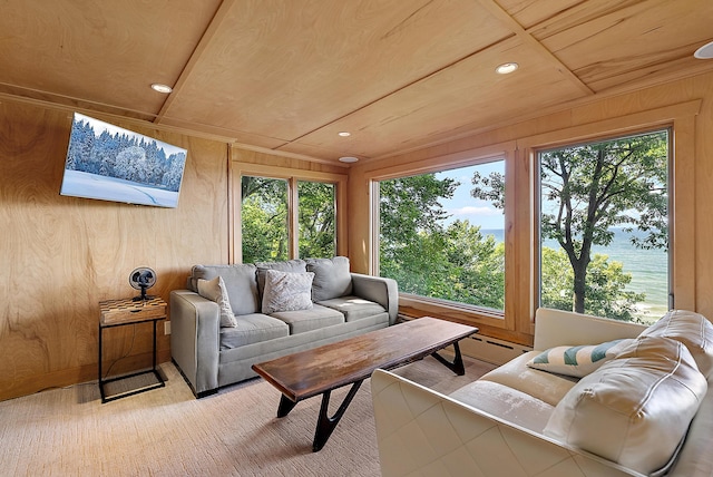 sunroom featuring a water view, wood ceiling, and a wealth of natural light