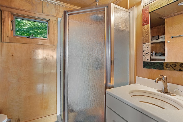 bathroom with a shower stall and vanity