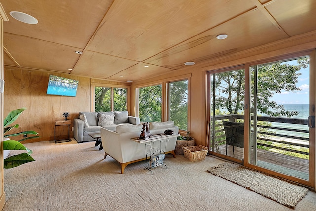 sunroom / solarium with a water view and plenty of natural light