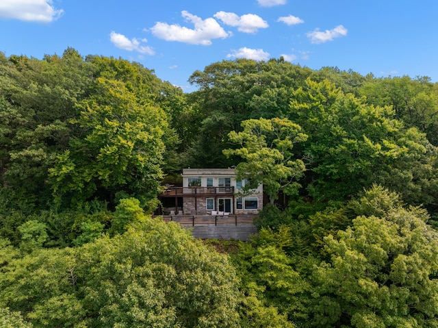 birds eye view of property featuring a view of trees