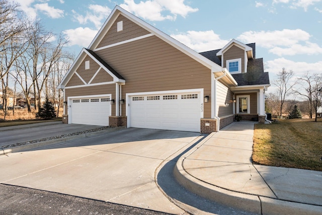 craftsman-style home featuring concrete driveway, brick siding, roof with shingles, and an attached garage