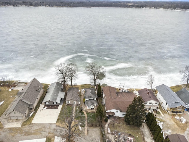 drone / aerial view with a water view and a residential view