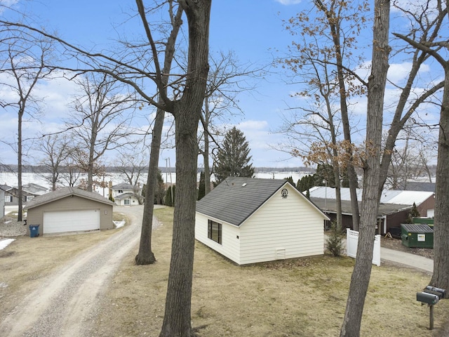 view of property exterior featuring a garage and an outdoor structure