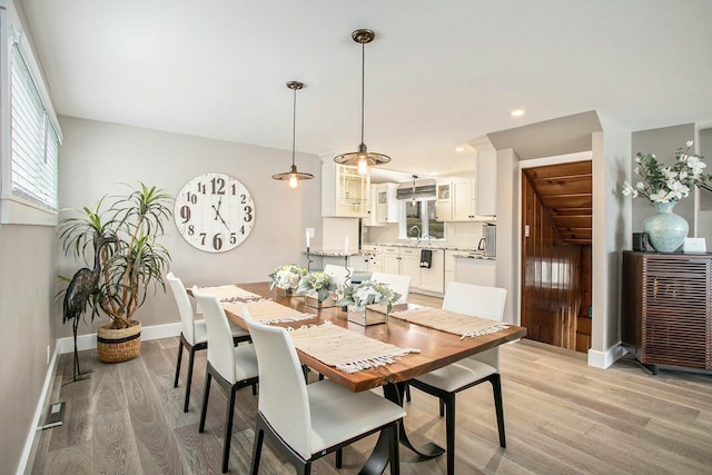 dining space featuring recessed lighting, baseboards, and light wood finished floors