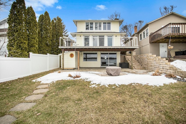 rear view of house featuring a lawn, a patio, stairway, fence, and a wooden deck