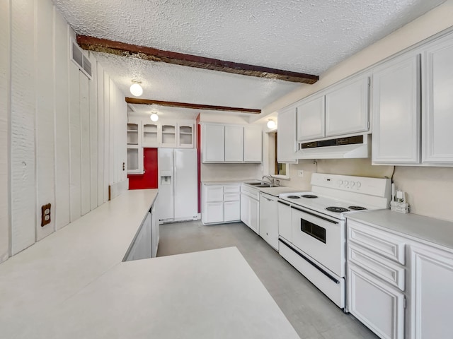 kitchen featuring white appliances, under cabinet range hood, white cabinetry, and a textured ceiling