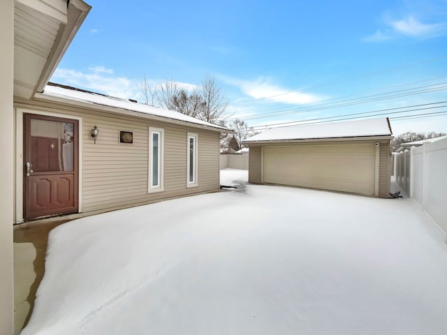 exterior space with an outdoor structure, fence, and a detached garage