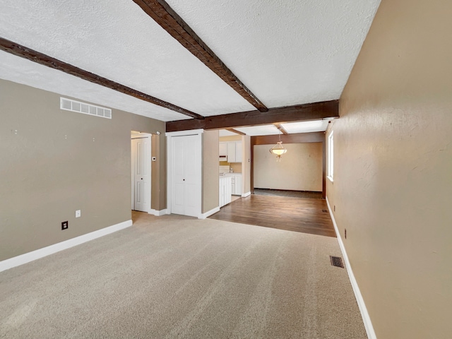 15455 Mulberry St, Southgate, MI 48195 - unfurnished living room with baseboards, visible vents, and a textured ceiling