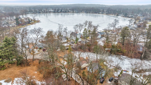 aerial view featuring a water view and a wooded view