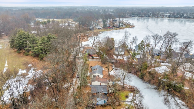 birds eye view of property featuring a water view, a wooded view, and a residential view