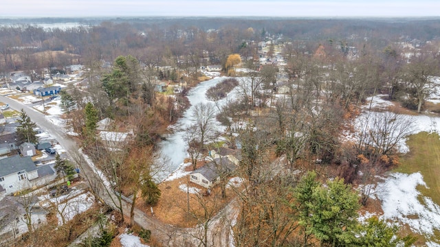 snowy aerial view featuring a forest view