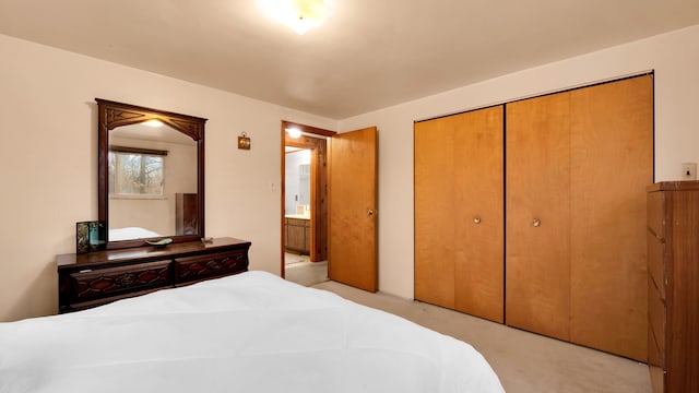 bedroom with a closet and light carpet