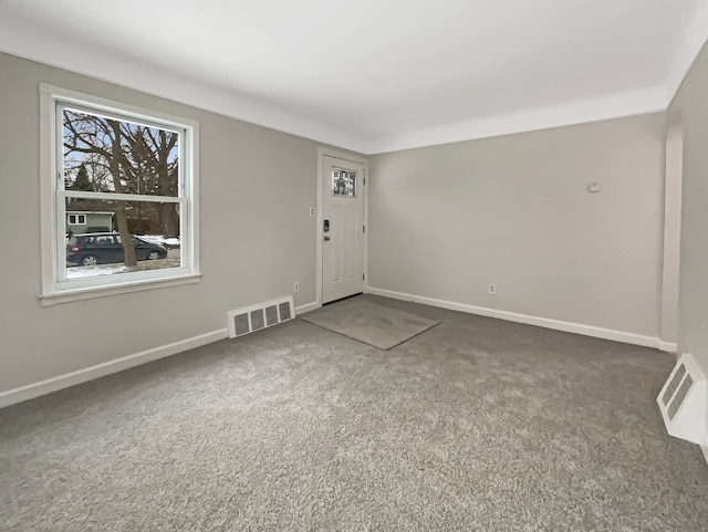 carpeted empty room with baseboards and visible vents