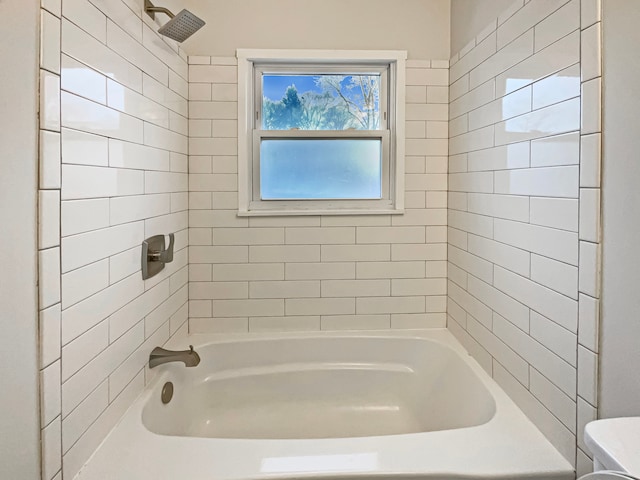 bathroom featuring bathtub / shower combination and toilet