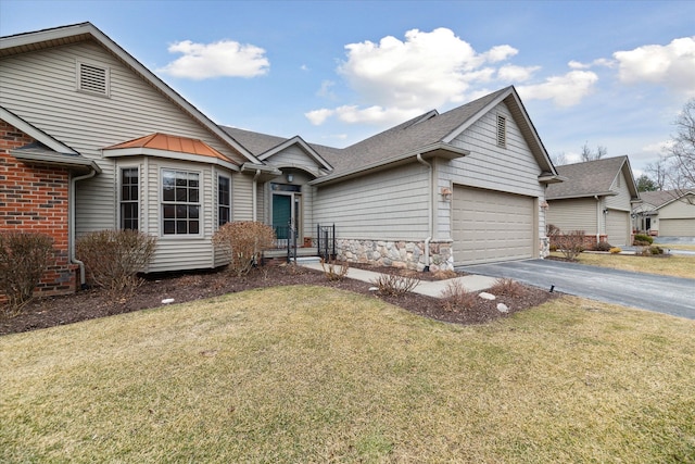 ranch-style house with an attached garage, driveway, stone siding, roof with shingles, and a front yard