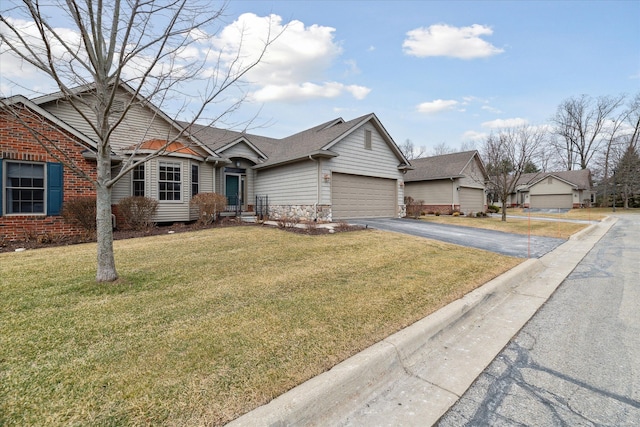 view of front facade with a garage, a shingled roof, brick siding, driveway, and a front yard