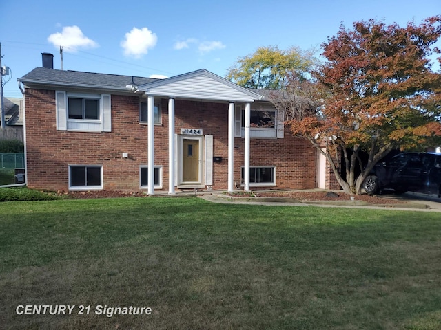 view of front of home with brick siding and a front lawn