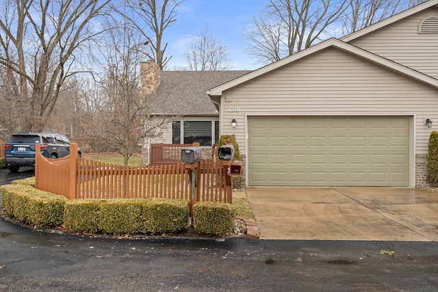 view of front of home featuring driveway, a garage, a chimney, roof with shingles, and fence