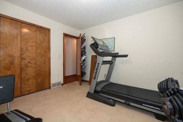 workout room with a textured ceiling and visible vents