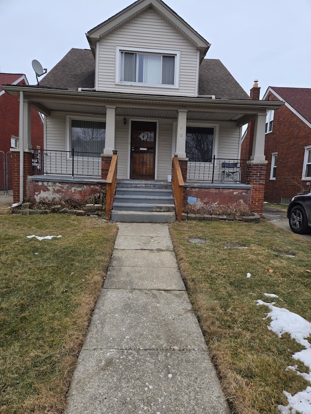 18080 Westphalia St, Detroit, MI 48205 - bungalow-style house featuring a porch, a front lawn, and roof with shingles