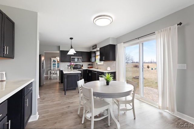 dining area with light wood finished floors and baseboards