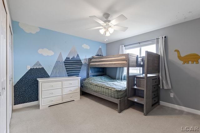 carpeted bedroom with ceiling fan and baseboards